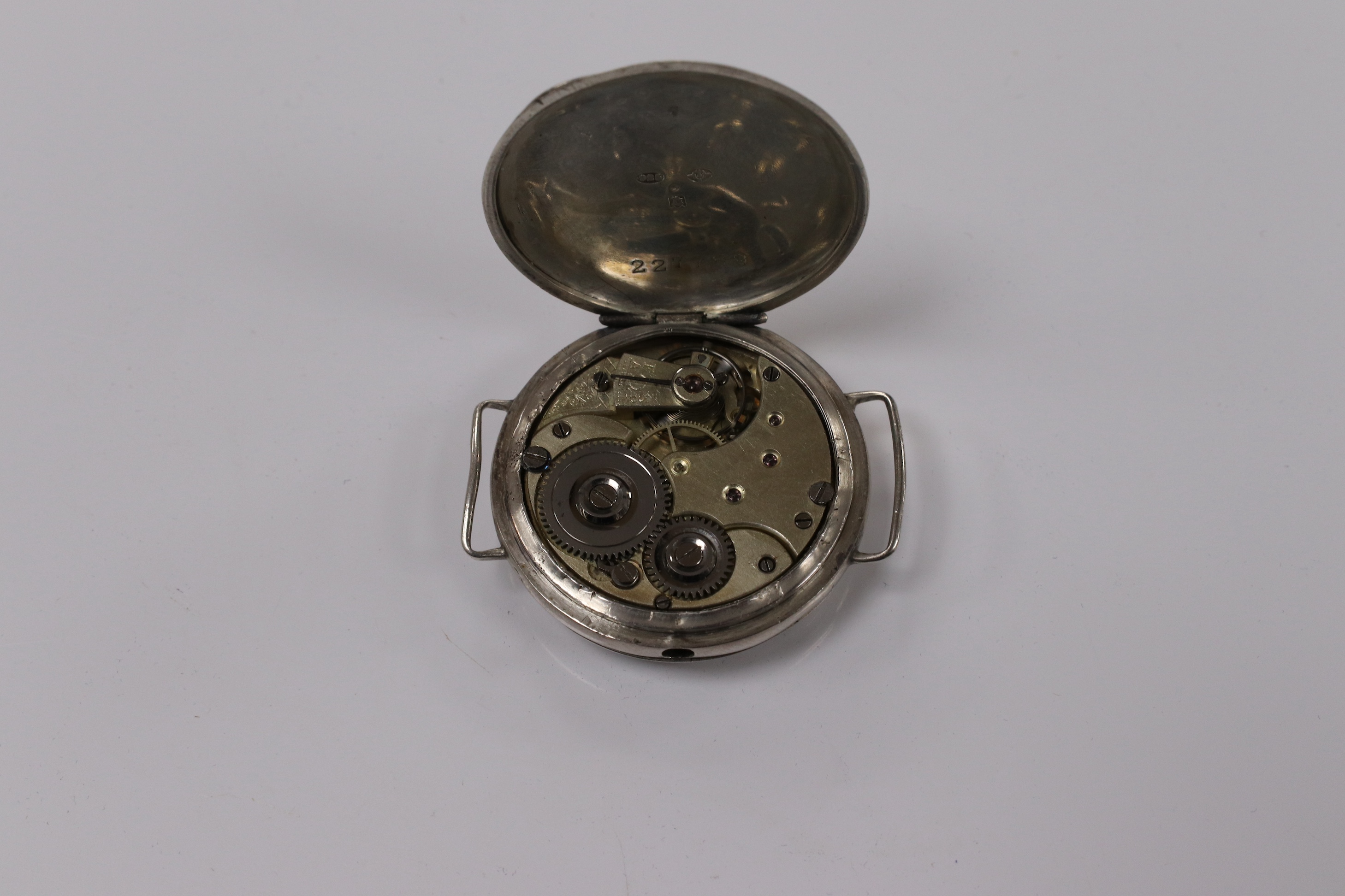 A George V silver manual wind trench watch with 'telephone dial' shrapnel guard, case import marked for London, 1917, case diameter 35mm, lacking winding crown. No strap. Condition - poor